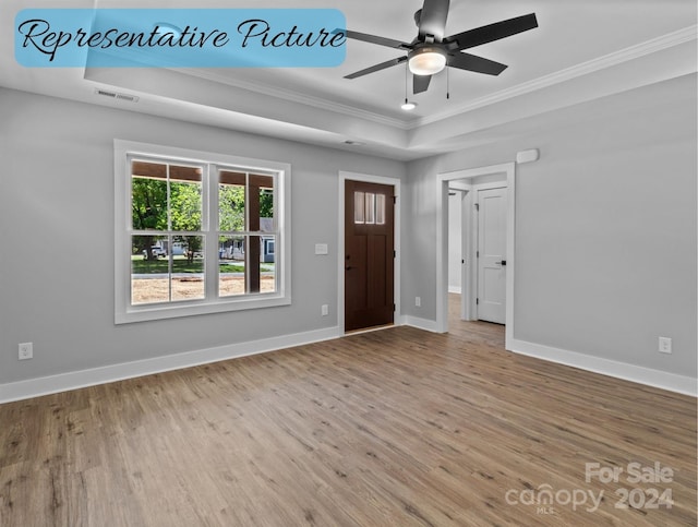 entrance foyer with ceiling fan, crown molding, light hardwood / wood-style floors, and a raised ceiling