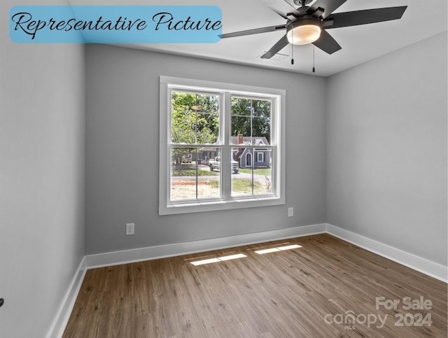 empty room featuring ceiling fan and wood-type flooring