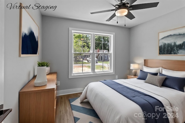 bedroom with ceiling fan and light wood-type flooring