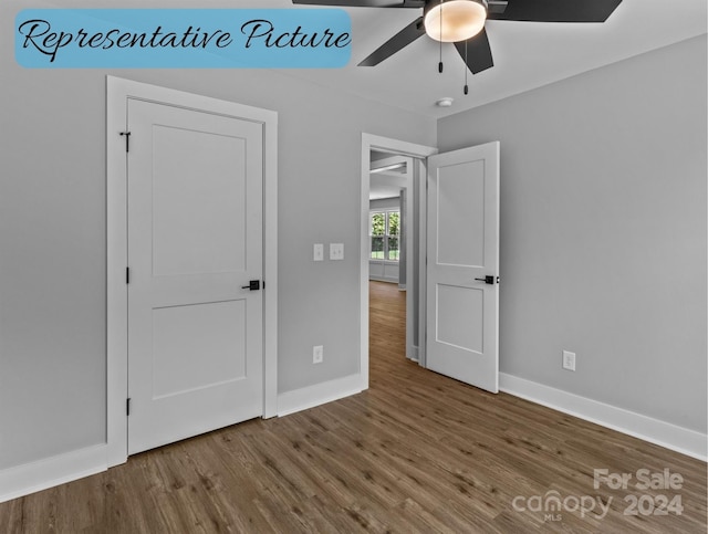 unfurnished bedroom with ceiling fan and wood-type flooring