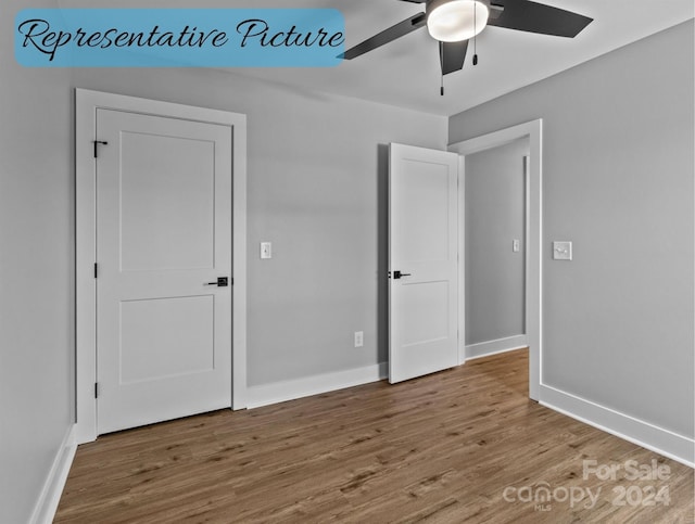 unfurnished bedroom with ceiling fan and wood-type flooring