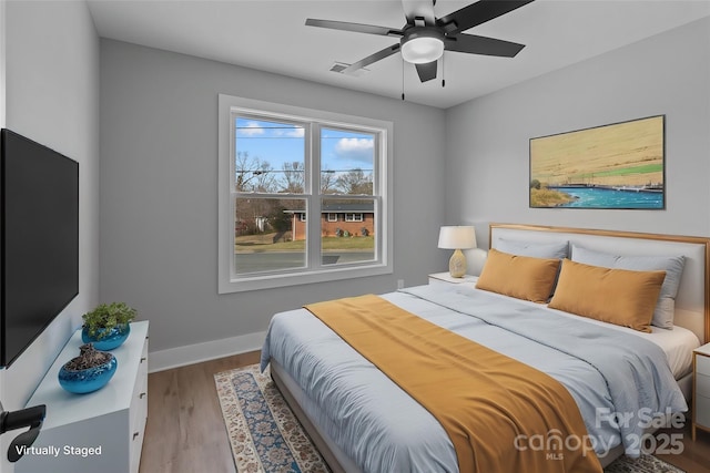 bedroom with hardwood / wood-style flooring and ceiling fan