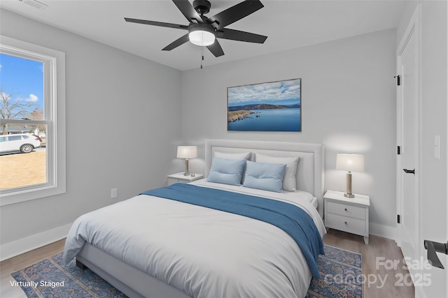 bedroom with dark wood-type flooring and ceiling fan