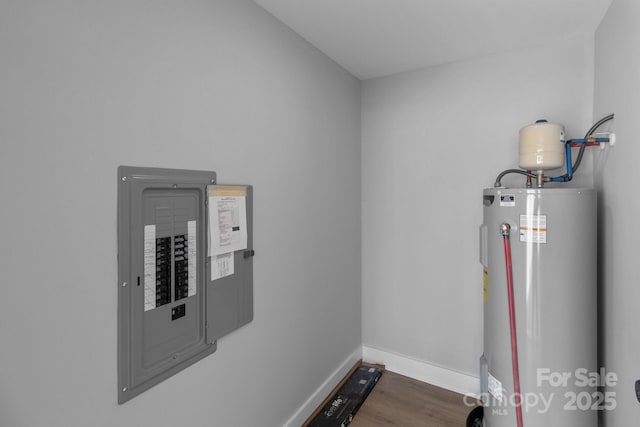 utility room featuring electric panel and electric water heater