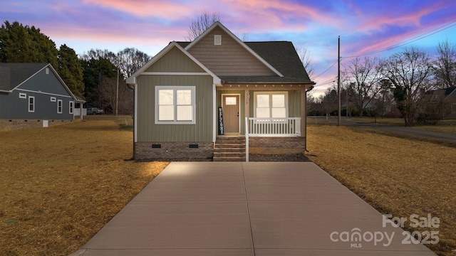 view of front of home with a porch and a yard