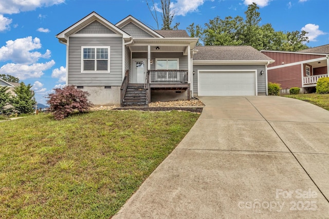 view of front of property featuring a front yard, a porch, and a garage