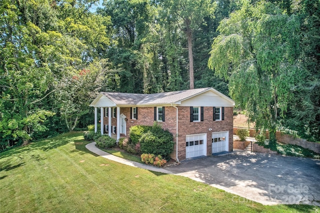 view of front of property with a garage and a front yard