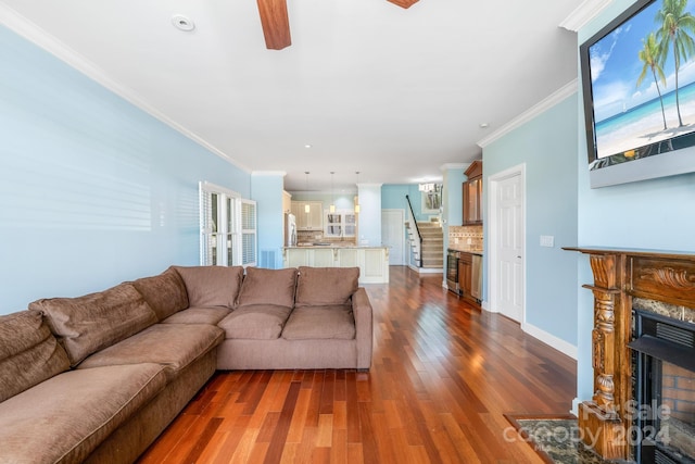 living room featuring ceiling fan, wine cooler, dark hardwood / wood-style floors, and crown molding