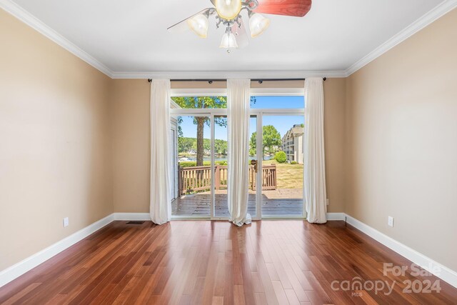 unfurnished room with ceiling fan, ornamental molding, and dark hardwood / wood-style flooring