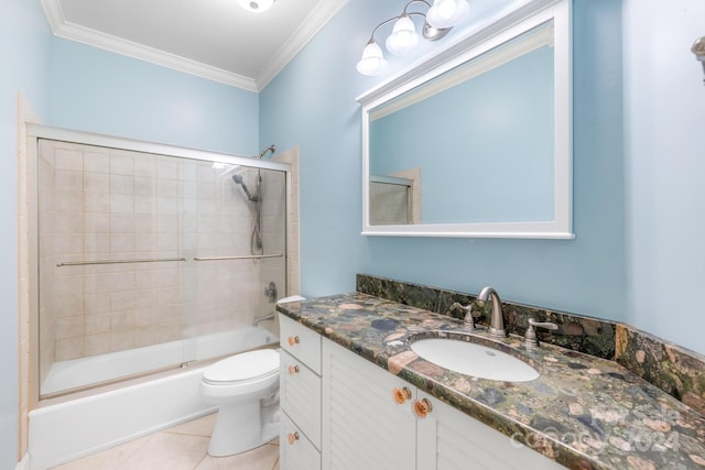 full bathroom featuring vanity, combined bath / shower with glass door, crown molding, toilet, and tile patterned floors