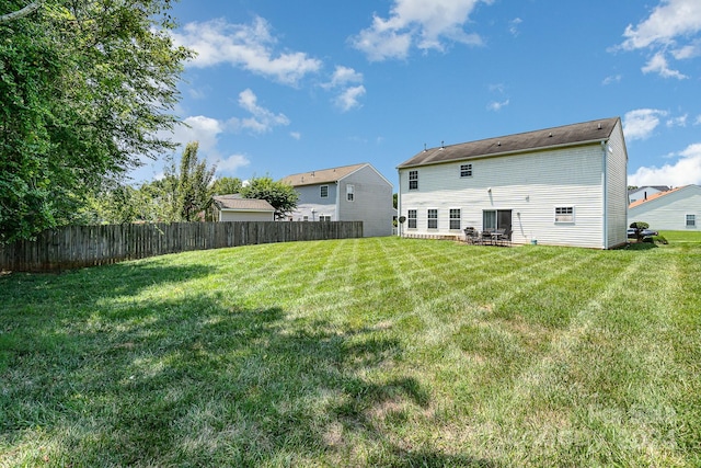 back of house with a yard