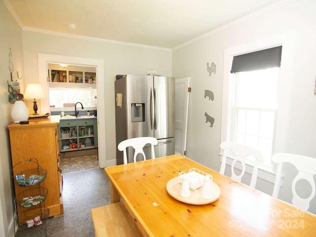 dining area with ornamental molding and sink