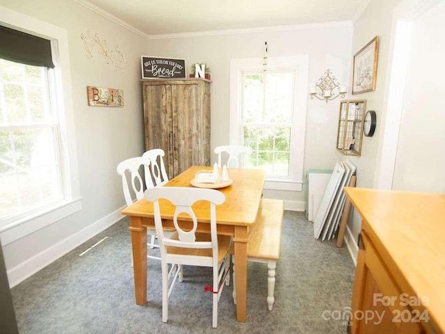 dining room with dark carpet and crown molding