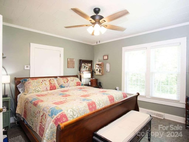 bedroom with crown molding, dark colored carpet, and ceiling fan