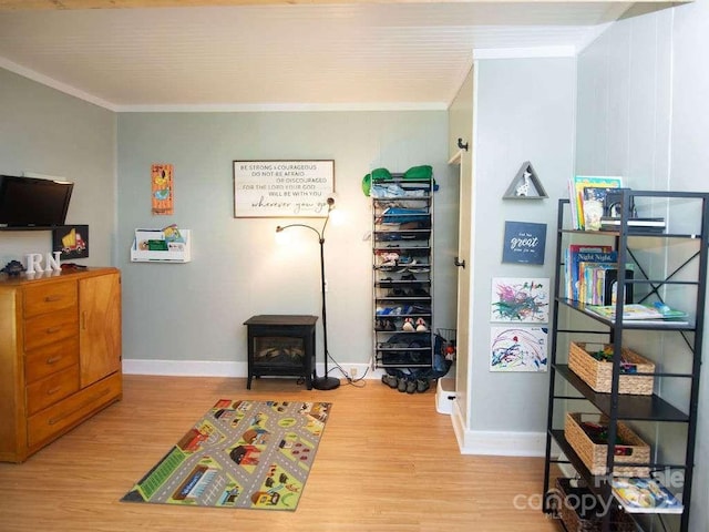 interior space with light hardwood / wood-style flooring and ornamental molding