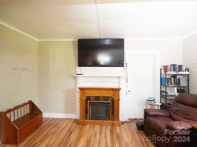 living room featuring wood-type flooring and ornamental molding