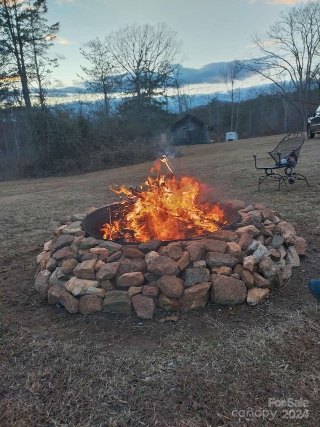 yard at dusk with a fire pit