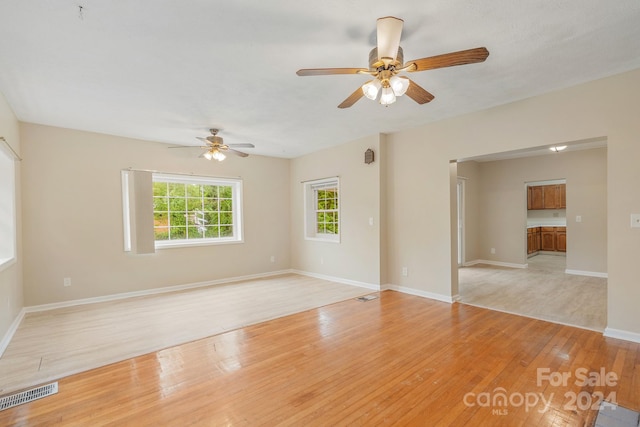 unfurnished room with light wood-type flooring and ceiling fan