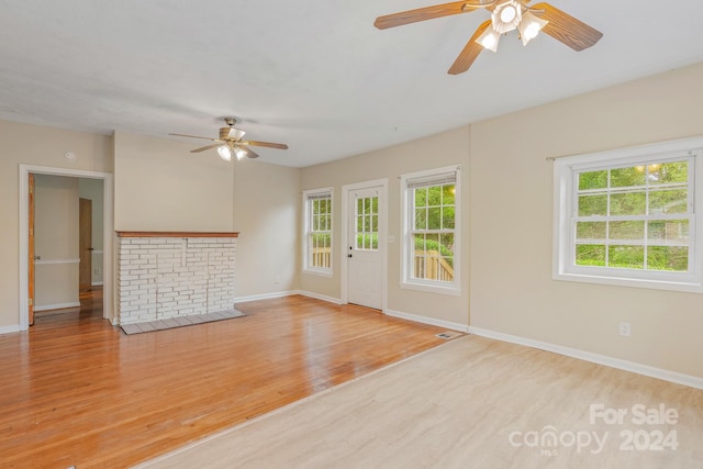 unfurnished living room featuring ceiling fan and light hardwood / wood-style floors