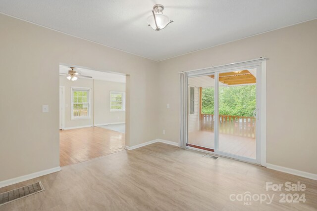 spare room with light hardwood / wood-style flooring and ceiling fan