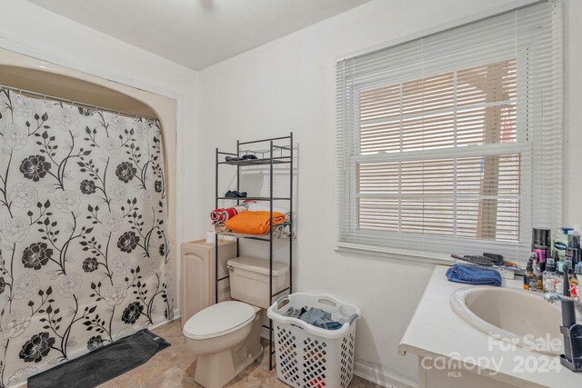 bathroom featuring tile patterned floors, toilet, and vanity