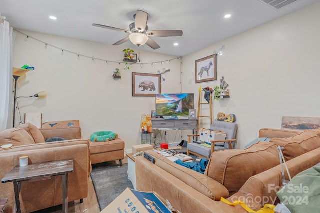 carpeted living room featuring ceiling fan