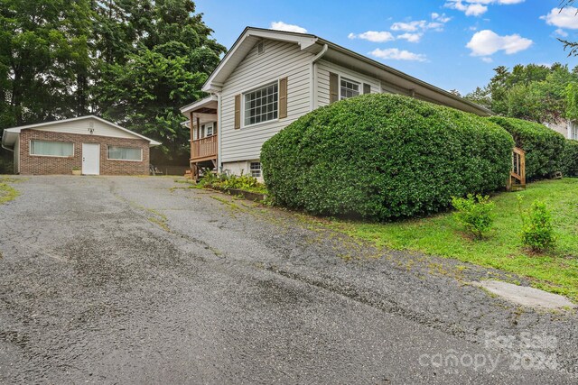 view of home's exterior featuring a garage and an outdoor structure