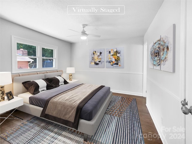 bedroom with ceiling fan and dark hardwood / wood-style floors