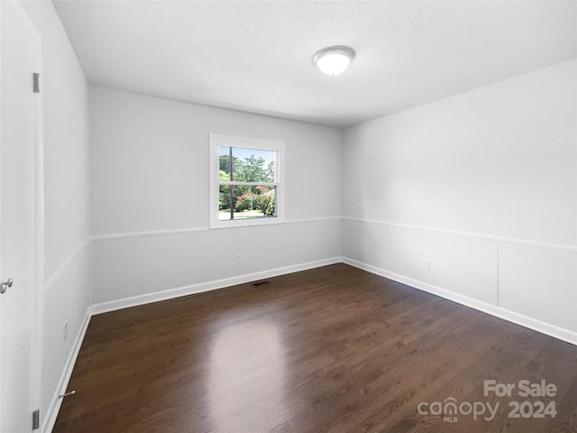 unfurnished room featuring dark hardwood / wood-style floors