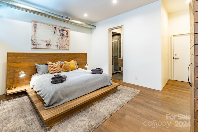 bedroom with hardwood / wood-style floors