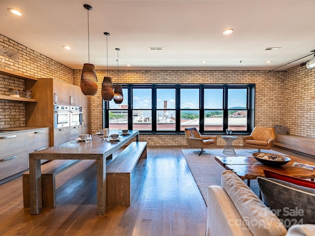 interior space with brick wall and dark hardwood / wood-style flooring