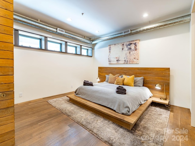 bedroom with hardwood / wood-style flooring