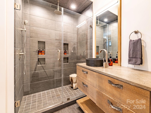 bathroom with an enclosed shower and vanity