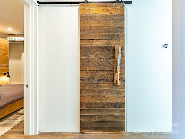 interior space with wood walls and a barn door