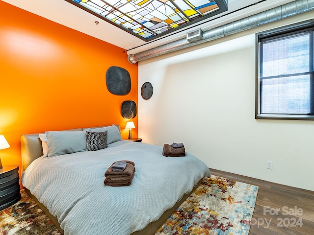 bedroom with hardwood / wood-style flooring