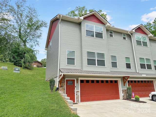 view of front of house with a garage and a front yard