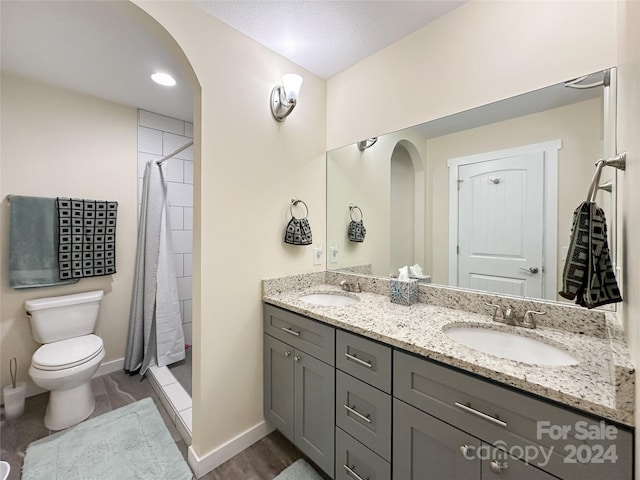 bathroom featuring toilet, vanity, a shower with shower curtain, and hardwood / wood-style flooring