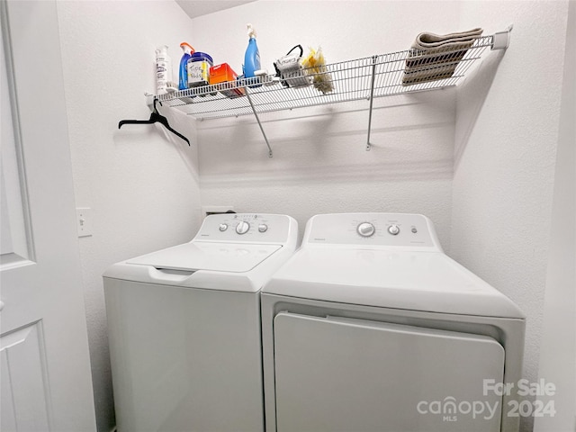 washroom featuring washing machine and dryer