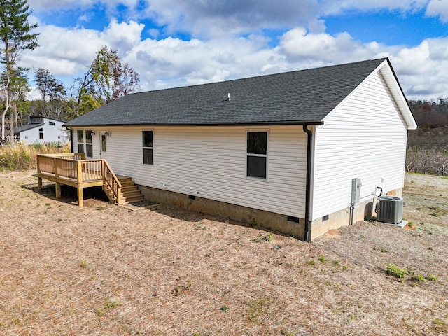 rear view of property with central AC unit and a deck