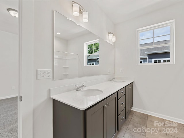 bathroom featuring vanity, tile patterned floors, and walk in shower