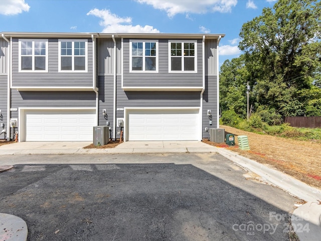 view of front of property with central AC unit and a garage