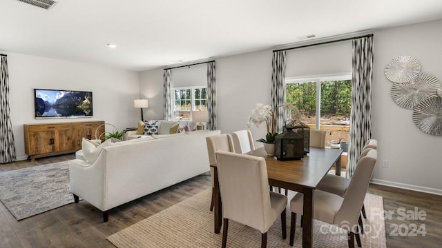 dining space with dark wood-type flooring and plenty of natural light