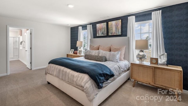 bedroom featuring carpet floors and ensuite bath