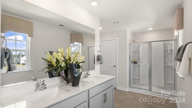 bathroom featuring an enclosed shower, vanity, and tile patterned floors