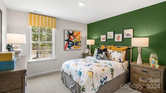 bedroom featuring light colored carpet