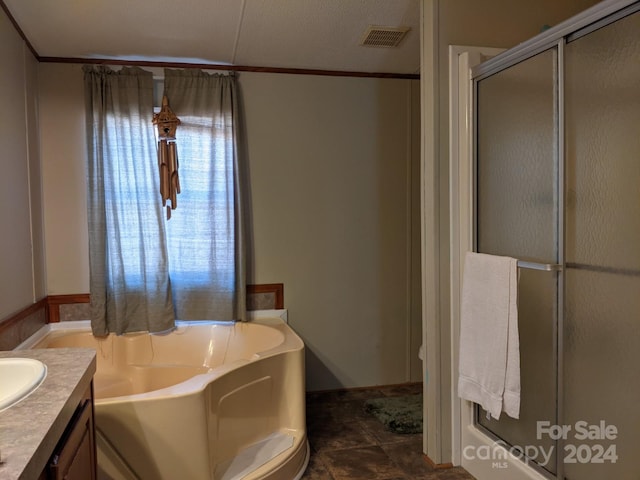 bathroom with vanity and independent shower and bath