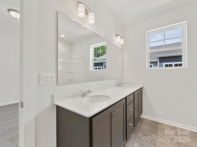 bathroom featuring walk in shower, vanity, and tile patterned floors