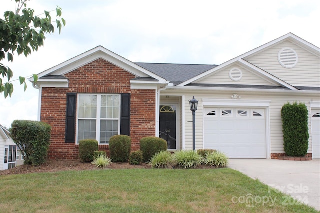 view of front of house featuring a garage and a front lawn