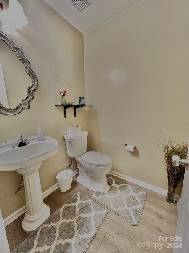 bathroom featuring toilet and hardwood / wood-style flooring