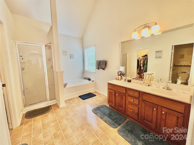 bathroom featuring tile patterned flooring, plus walk in shower, high vaulted ceiling, and dual bowl vanity